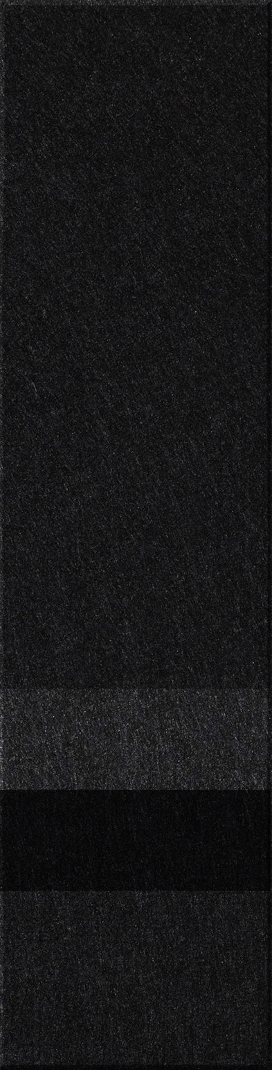 A felt tile that is dark gray on the top, lighter gray, black, and then a dark gray bottom. 