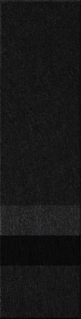 A felt tile that is dark gray on the top, lighter gray, black, and then a dark gray bottom. 