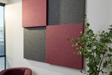 Red and grey acoustic panels on wall next to tree