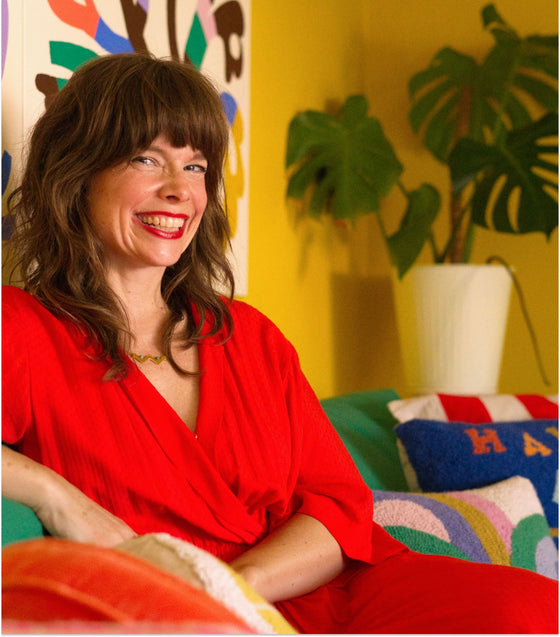 headshot of designer Elizabeth Olwen, with a bright and colorful living area