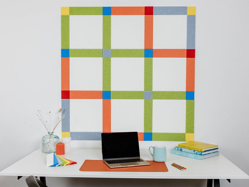 Pinnable Felt Right Wall Design Multicolor using yellow, orange, blue, green and red above a desk with a laptop on it and some books.