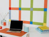 Pinnable Felt Right Wall Design Multicolor using yellow, orange, blue, green and red above a desk with a laptop on it and some books.