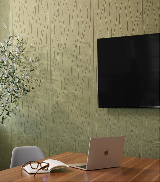 engraved green felt acoustic tiles on a conference room wall