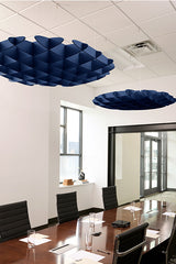 Two navy blue 3D cloud-shaped acoustic baffles suspended from ceiling above conference table.