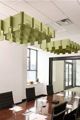 Green 3D modular baffle panels suspended from drop ceiling in office conference room setting.