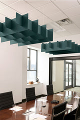 Dark teal grid-pattern acoustic baffles suspended from ceiling above conference table in office space.