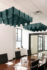 Teal 3D cloud-shaped acoustic baffles suspended from ceiling above conference table.