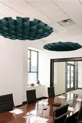 Dark teal 3D cloud-shaped acoustic baffles suspended from white drop ceiling in modern office conference room.