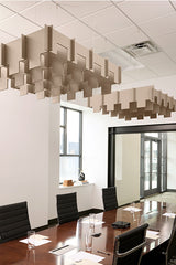 Tan 3D cloud-shaped acoustic baffles suspended from ceiling above conference table.