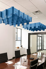 Blue 3D modular cloud baffles suspended from drop ceiling in office meeting room.