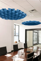 Two blue 3D cloud-shaped acoustic baffles suspended from ceiling in modern office space.