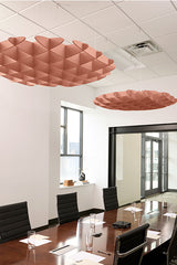 Rose gold 3D cloud-shaped acoustic baffles suspended from white drop ceiling in modern office conference room.