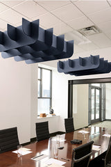 Dark blue 3D cloud-shaped acoustic baffles suspended from ceiling above conference table.
