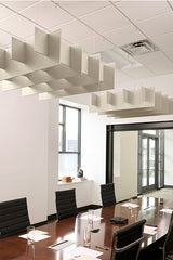 White modular grid baffles suspended from ceiling above conference table in office space.