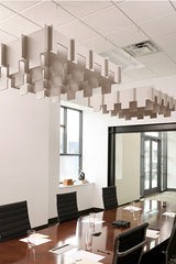 Beige 3D cloud-shaped acoustic baffles suspended from ceiling in modern office conference room.