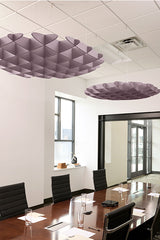 Purple foil 3D cloud baffles suspended from ceiling in modern office conference room.