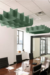 Green acoustic baffle panels suspended from ceiling above conference table in modern office space.
