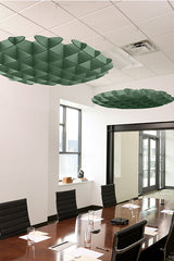 Two green 3D cloud-shaped foil baffles suspended from ceiling in modern office conference room.