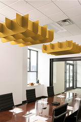 Yellow 3D cloud-shaped acoustic baffles suspended from ceiling above conference table.
