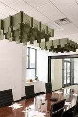 Sage green 3D baffle panels suspended from drop ceiling above conference table in office space.