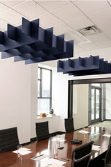 Dark blue grid-pattern acoustic baffles suspended from ceiling above conference table in office space.
