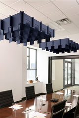 Navy blue 3D acoustic baffle panels suspended from ceiling in modern office conference room.