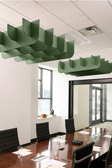 Green wavy acoustic baffles suspended from ceiling above conference table in office space.