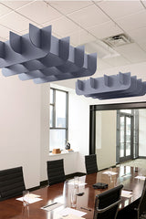 Gray cloud-shaped acoustic baffles suspended from ceiling above conference table in office space.