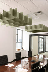Sage green 3D grid acoustic baffles suspended from drop ceiling above conference table.