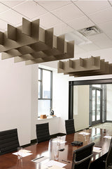 Tan 3D grid acoustic baffles suspended from ceiling above conference table in office space.