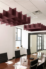 Burgundy 3D grid ceiling baffles suspended above conference table in office meeting room.