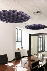 Dark blue 3D cloud-shaped acoustic baffles suspended from white drop ceiling in modern office conference room.