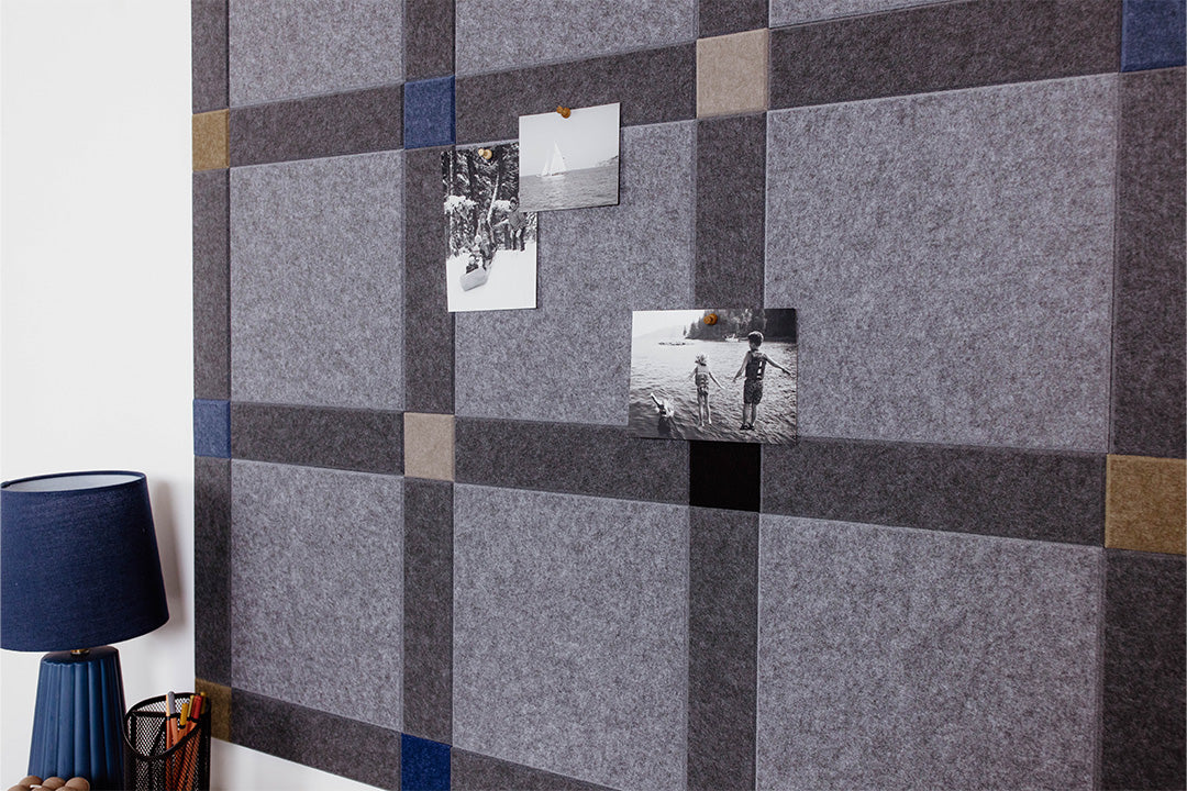 Pinnable Felt Right sound absorbing pinboard in a colorway that encourages focus. It has greys, blues, and neutrals. Photos are pinned to the pinboard.