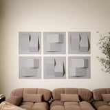 Light grey acoustic felt tiles with peak point designs along a wall above a couch