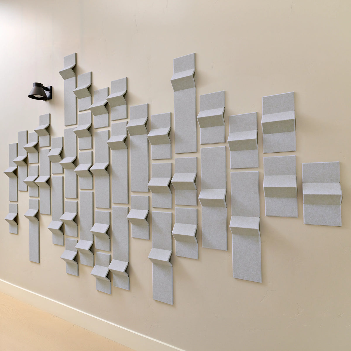 Light grey felt acoustic tiles on a wall in a modern design 