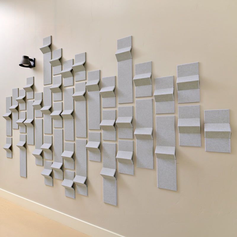 Light grey felt acoustic tiles on a wall in a modern design 