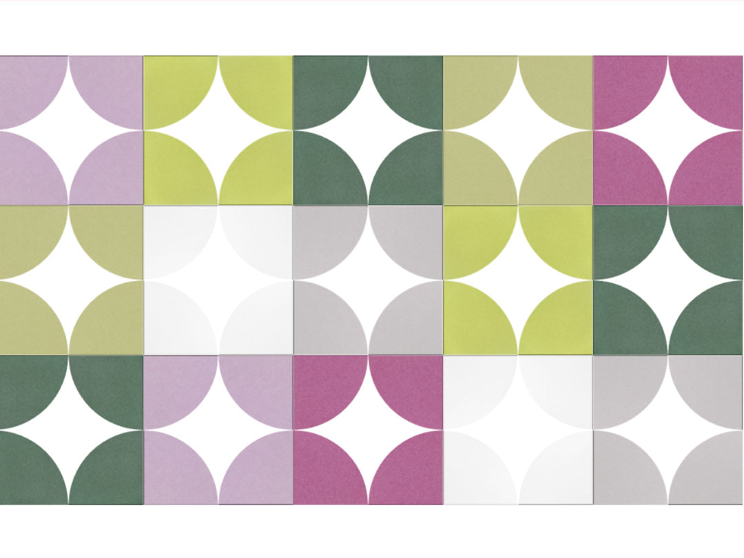 Patterned paper with green, purple, and white circles on a white background