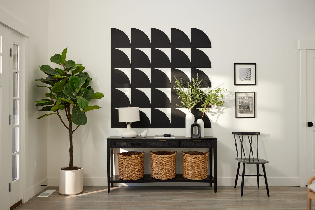 Modern interior design with geometric wall art, console table, and decorative items.