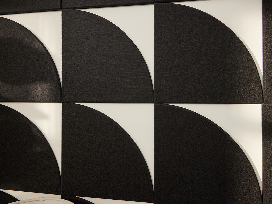 A Felt Right wall art design close up of the quarter circles in the shade of black on a white wall