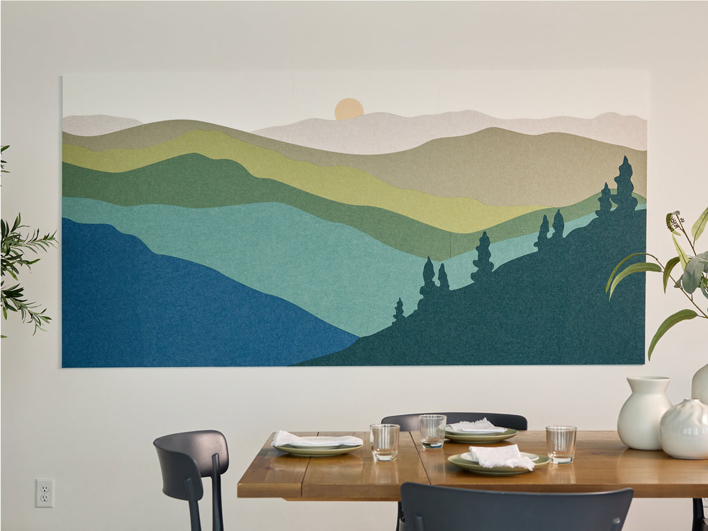 Great Smoky Mountains felt right wall art on a white wall behind a dining room table. The design has blues, greens, and creams in it.