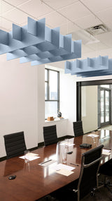 Blue geometric ceiling baffle suspended above conference table in office space.