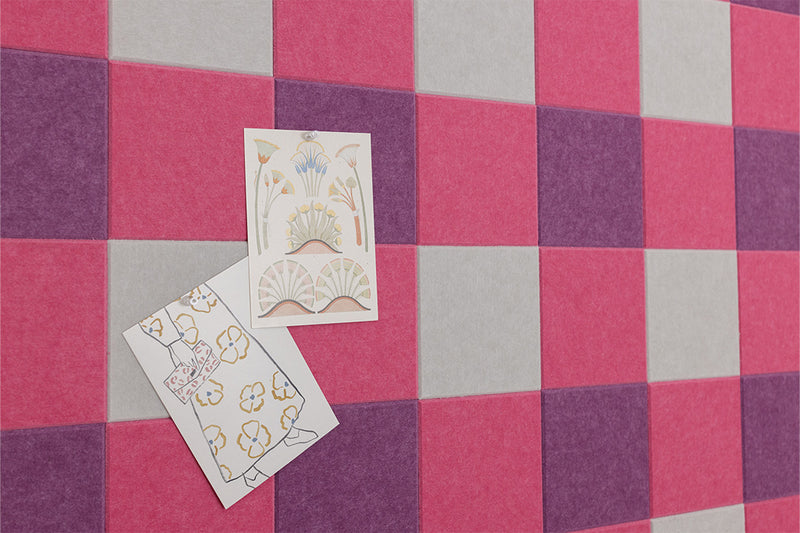 Pink pinboard with two cards pinned on them. 