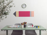 Color swatch wall art above a desk with stationery items
