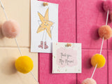 Two cards on a pink and beige background with pom-pom decorations