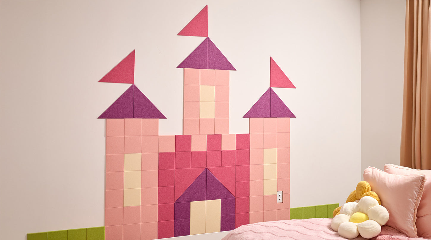 Children's room with a pink castle wall decal and a bed with pillows.