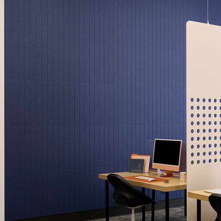 Blue engraved accent wall with desk and divider