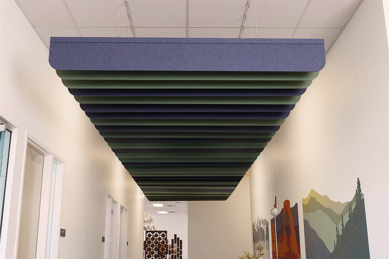 Ceiling acoustic panel in a hallway with white walls and a colorful mural.