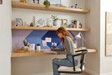 A Felt Right pinnable design in shades of blue and purple below a shelf and above a desk with a girl sitting at the desk.