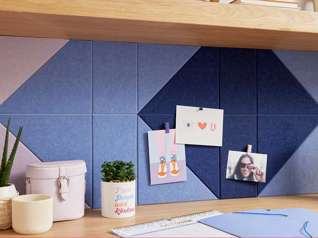A Felt Right pinnable design in shades of blue and purple felt tiles below a shelf and above a desk with photos pinned on the tiles