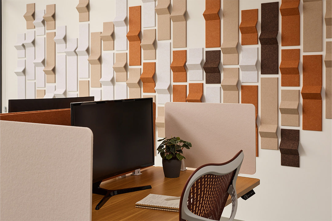 Modern office setup with a textured wall panel design and desk dividers.